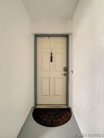 a view of a hallway with of white walls