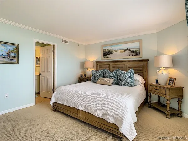 a bedroom with a bed and a lamp on table