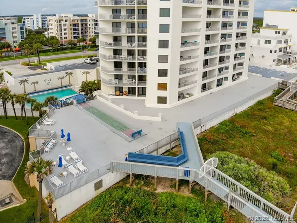 a view of a swimming pool with outdoor seating and a patio