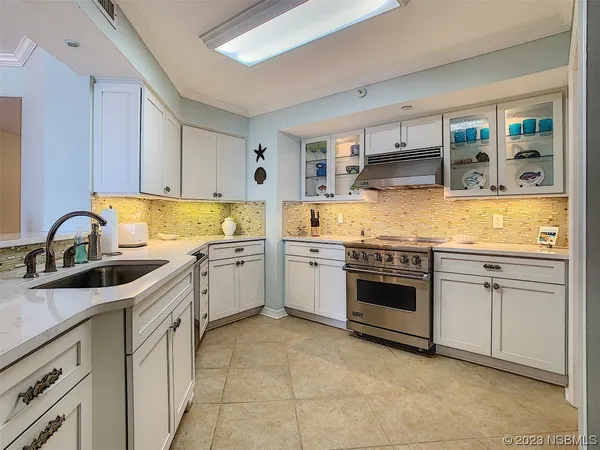 a kitchen with stainless steel appliances granite countertop a sink and cabinets