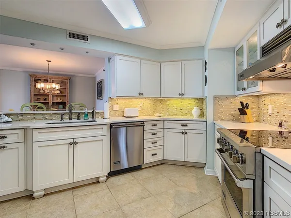 a kitchen with cabinets appliances and a counter