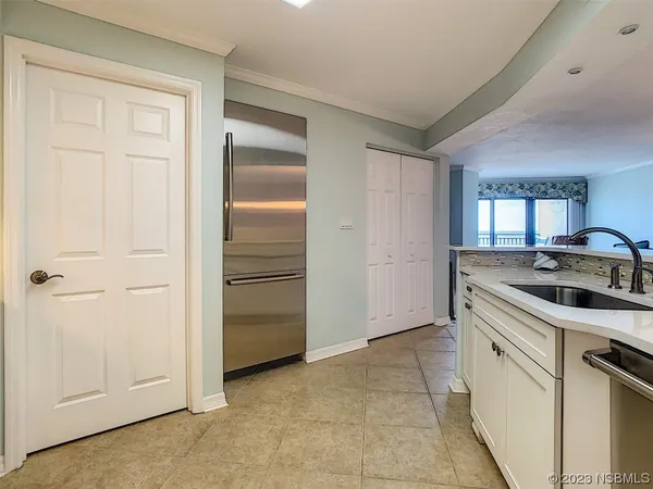 a kitchen with a sink stove and refrigerator