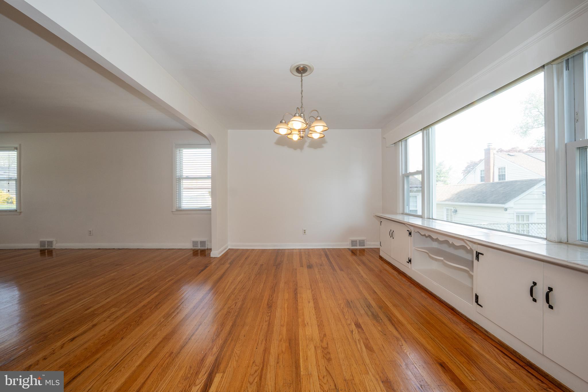 1305 Center Road Drexel Hill, PA 19026 - Photo 11 of 37 a view of an empty room with wooden floor and a window