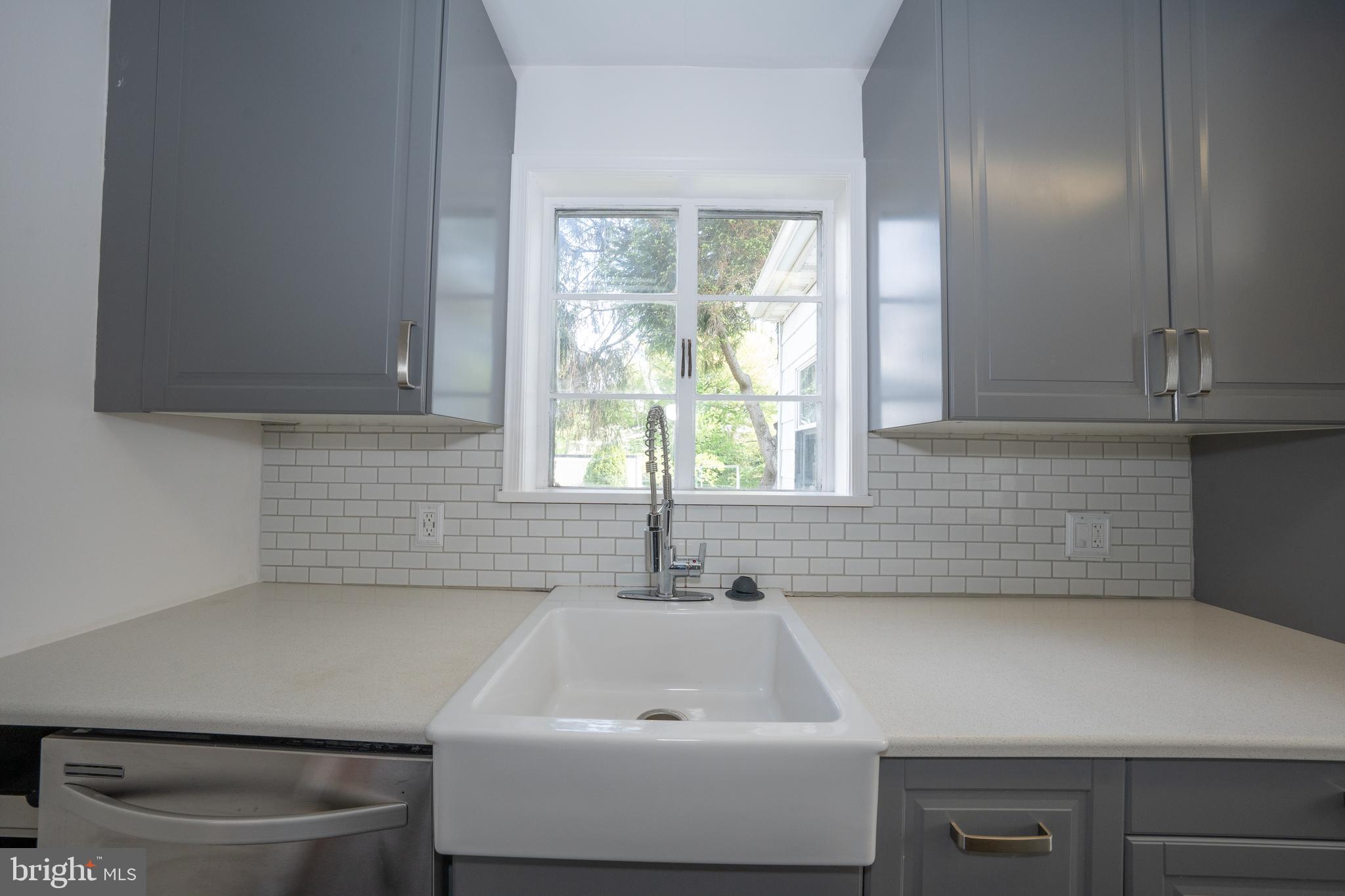 1305 Center Road Drexel Hill, PA 19026 - Photo 16 of 37 a bathroom with a sink a toilet and a window