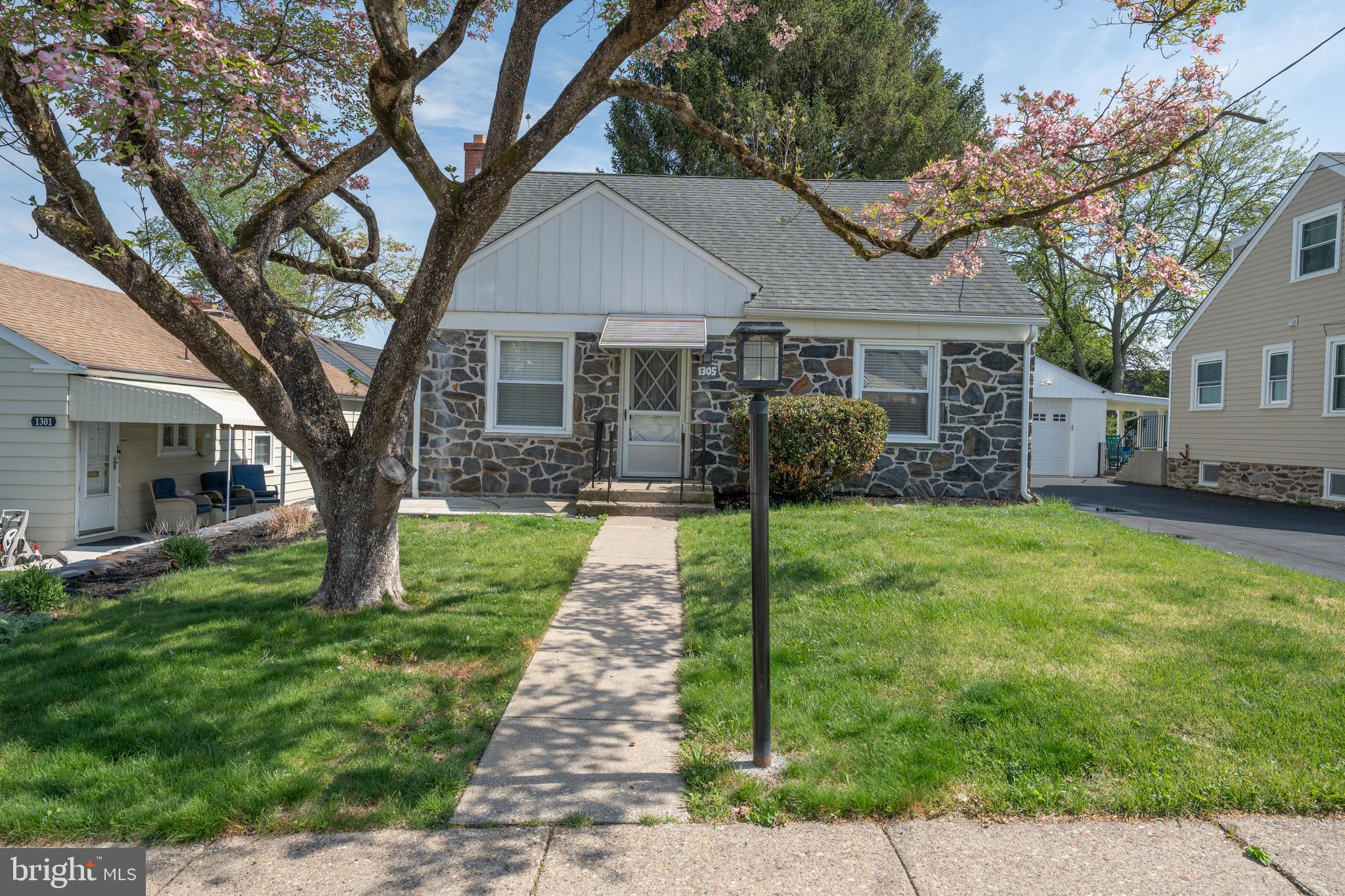 1305 Center Road Drexel Hill, PA 19026 - Photo 2 of 37 a front view of a house with garden