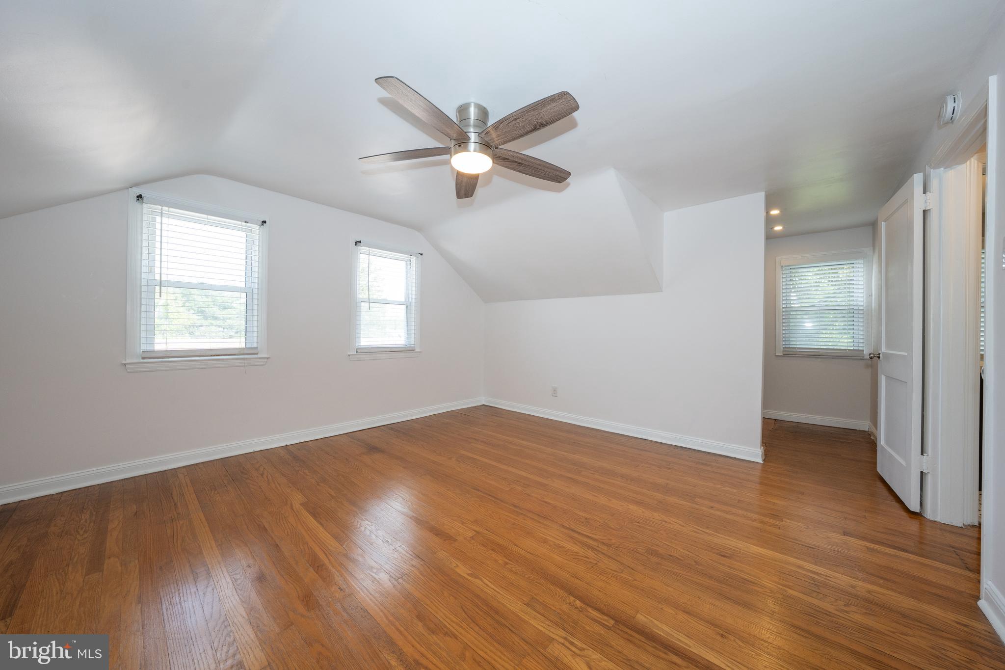 1305 Center Road Drexel Hill, PA 19026 - Photo 26 of 37 an empty room with wooden floor fan and windows