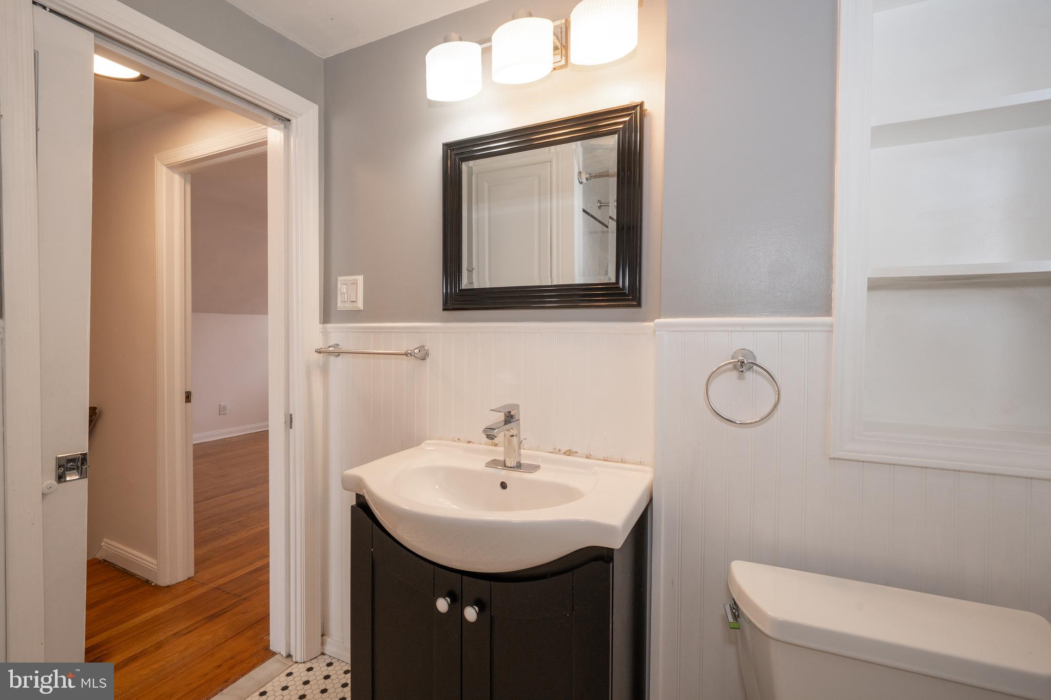 1305 Center Road Drexel Hill, PA 19026 - Photo 27 of 37 a bathroom with a toilet sink and mirror