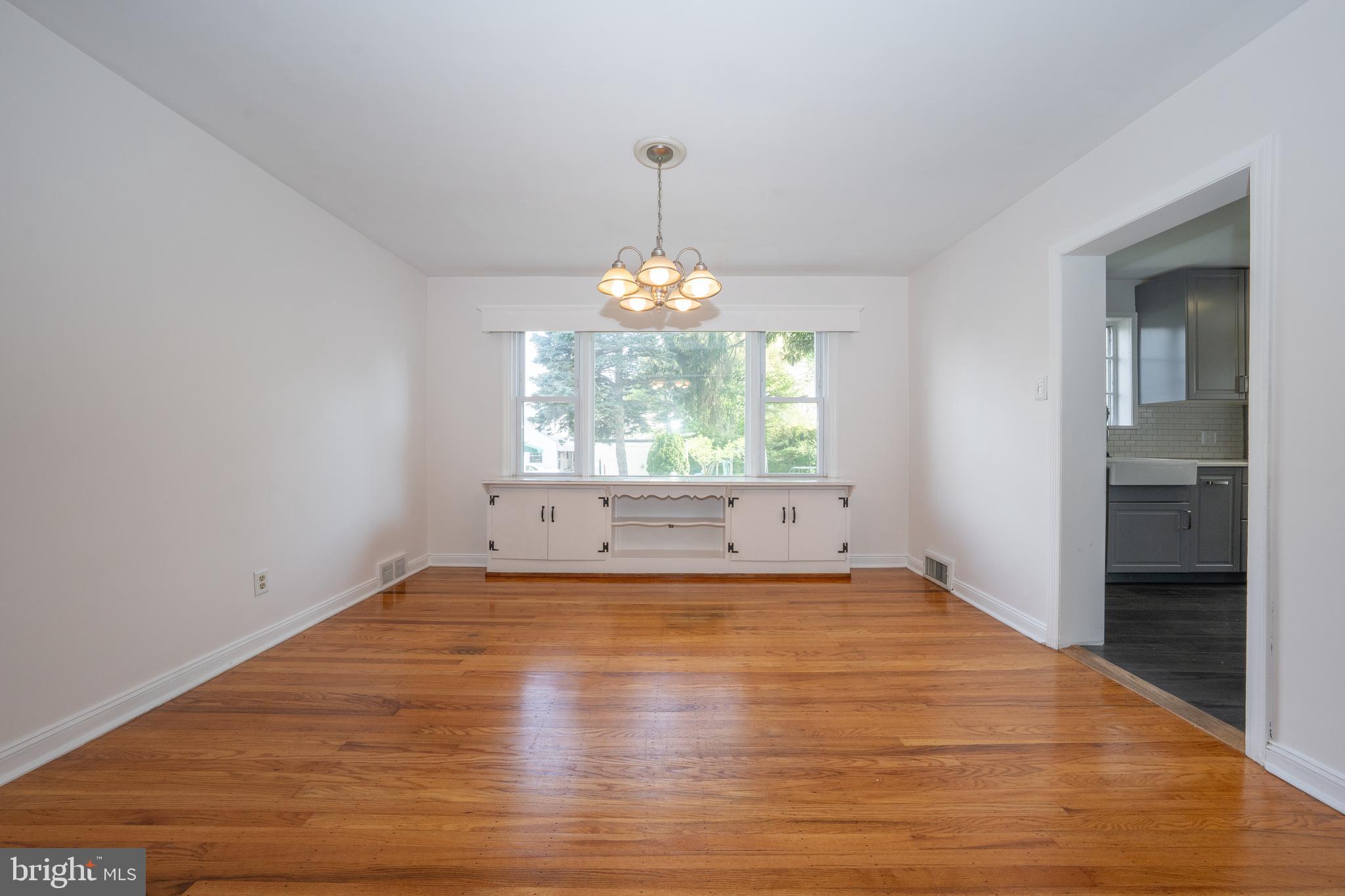 1305 Center Road Drexel Hill, PA 19026 - Photo 8 of 37 a view of an empty room with wooden floor and a window