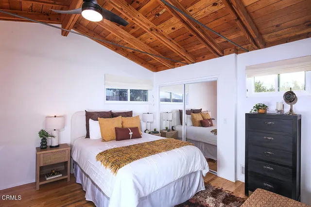 a bedroom with a bed and a dresser