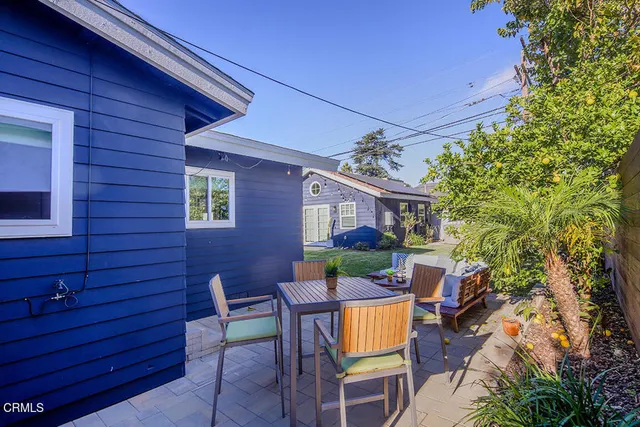 a view of a patio with table and chairs and potted plants