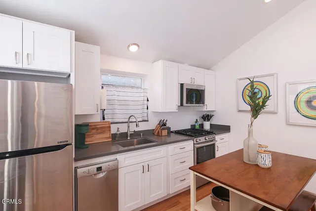a kitchen with refrigerator and stove
