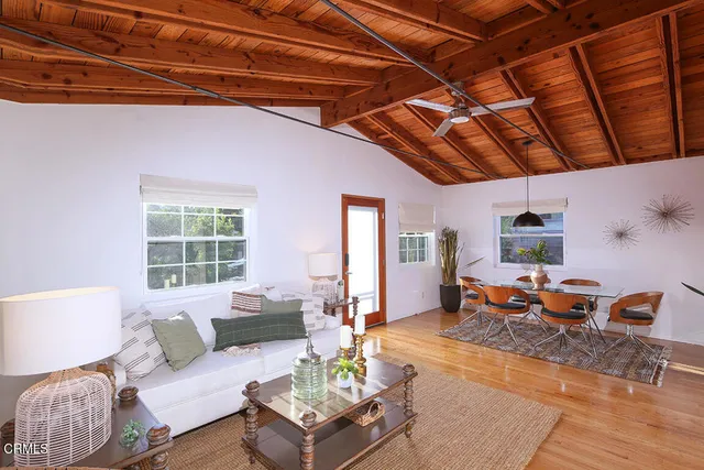 a living room with furniture a table and chairs