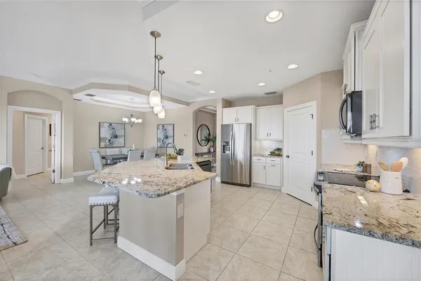 a spacious bathroom with a granite countertop sink mirror and shower
