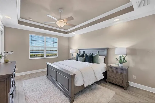 a bedroom with a bed and painting on the wall