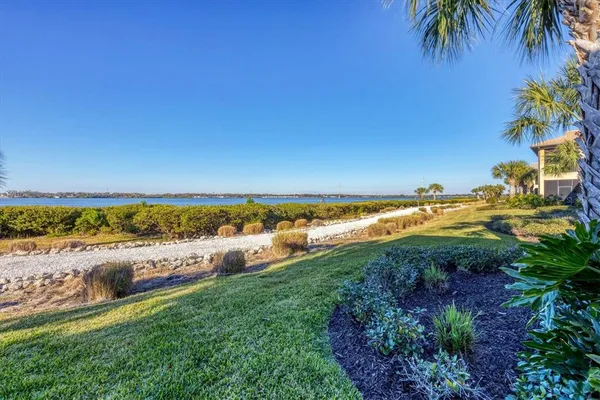 an aerial view of residential houses with outdoor space and river
