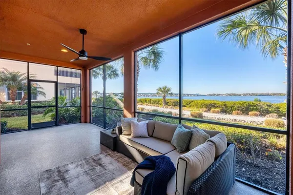 a large white kitchen with a large window and furniture