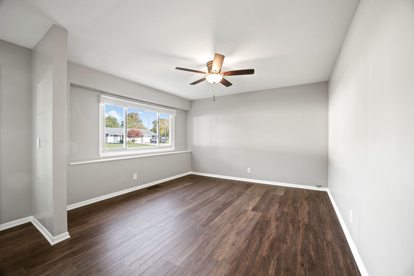 130 Saugatuck Road Montgomery, IL 60538 - Photo 3 of 31 an empty room with wooden floor and windows
