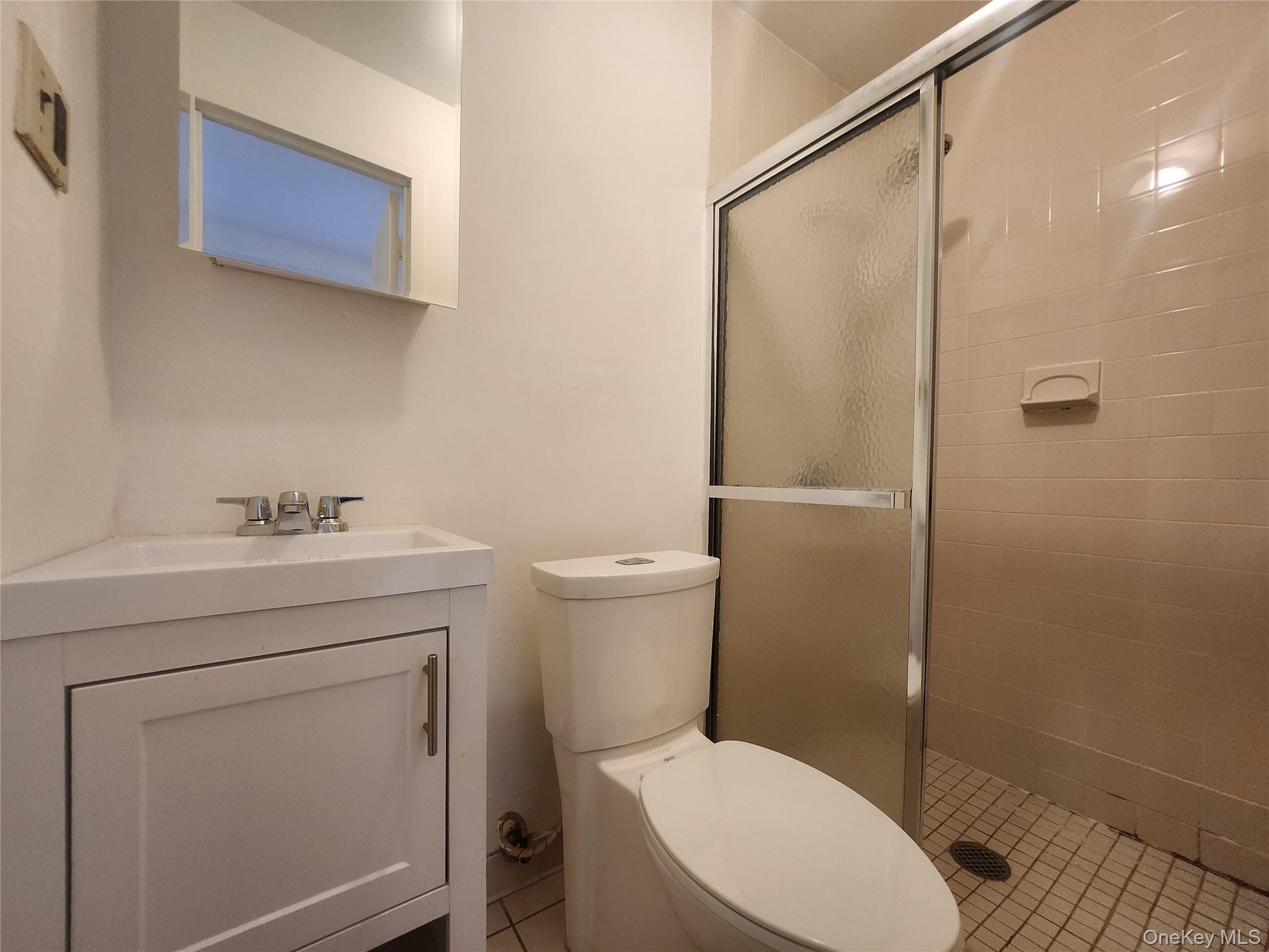 87-14 57th Road, Unit PHA Queens, NY 11373 - Photo 13 of 15 a bathroom with a sink a toilet and shower