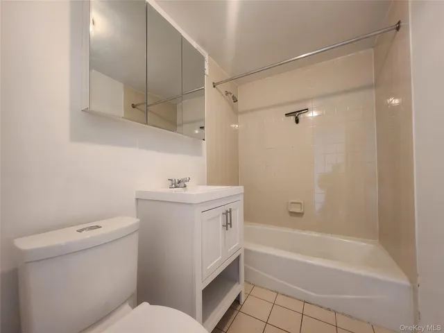 a bathroom with a granite countertop sink a toilet and shower