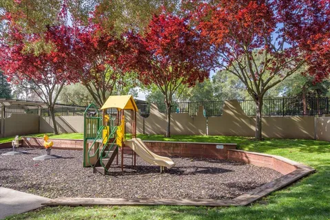 a view of outdoor space with playground and green space