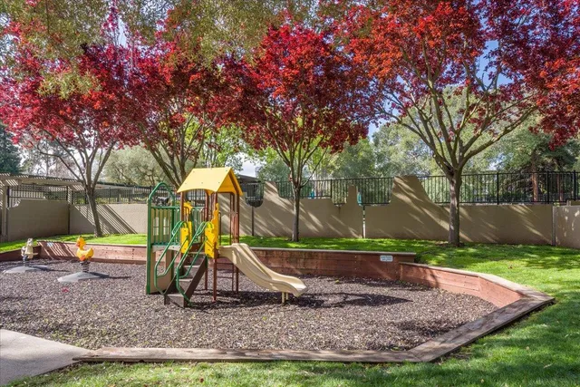 a view of outdoor space with playground and green space