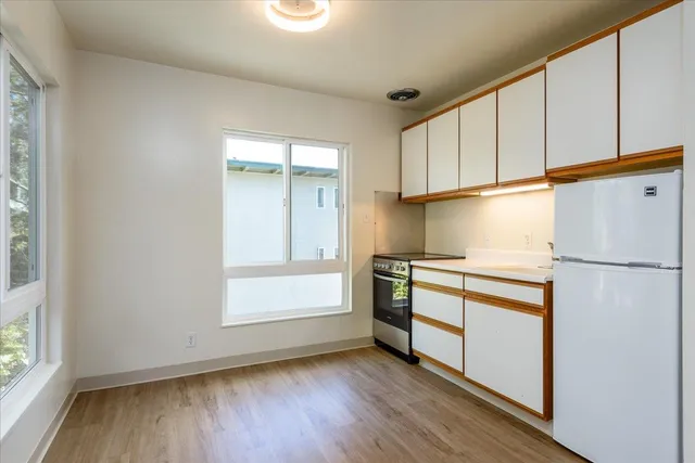 a kitchen with a refrigerator and a window