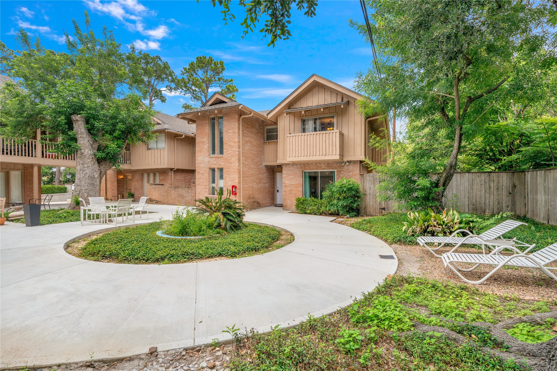 6303 Crab Orchard Road, Unit 3 Houston, TX 77057 - Photo 1 of 30 Welcome to the heart of the community. This expansive courtyard features a beautifully manicured circular garden, surrounded by crisp white lounge seating and modern Adirondack chairs. Whether you’re hosting a summer brunch or enjoying a quiet book under the shade of the majestic oaks, this outdoor space is a rare sanctuary of calm.