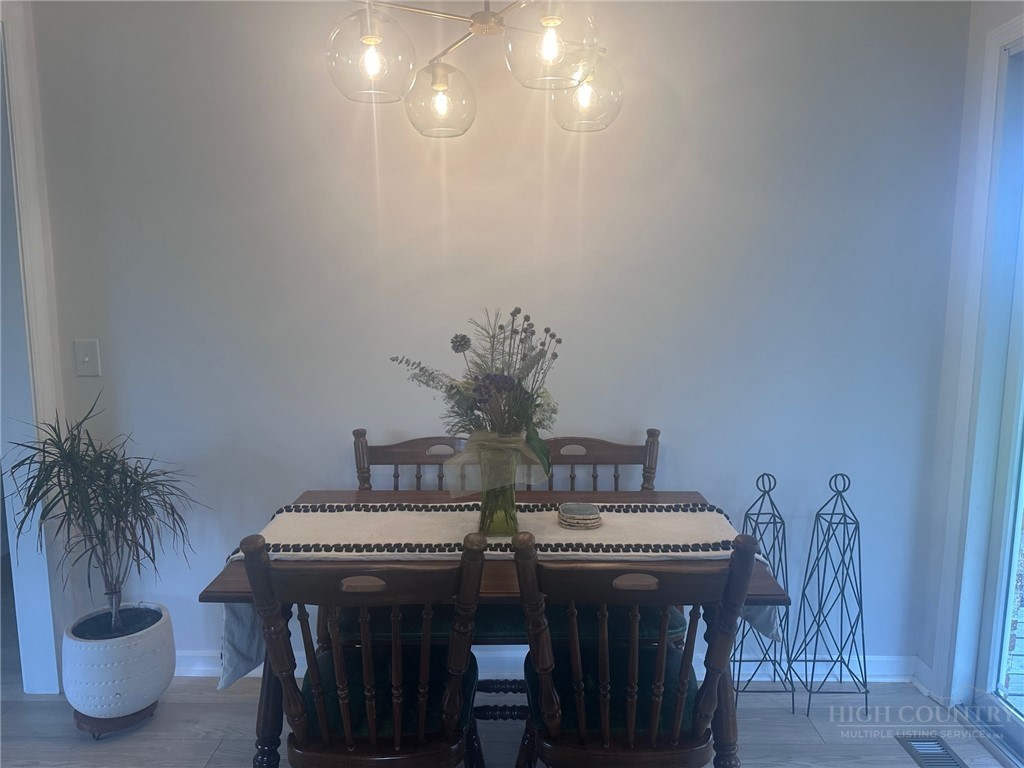 410 Cook Street Jefferson, NC 28640 - Photo 9 of 16 a view of a dining room with furniture and wooden floor