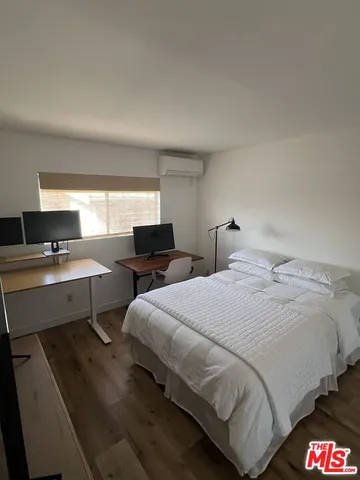a bedroom with a bed and view of living room