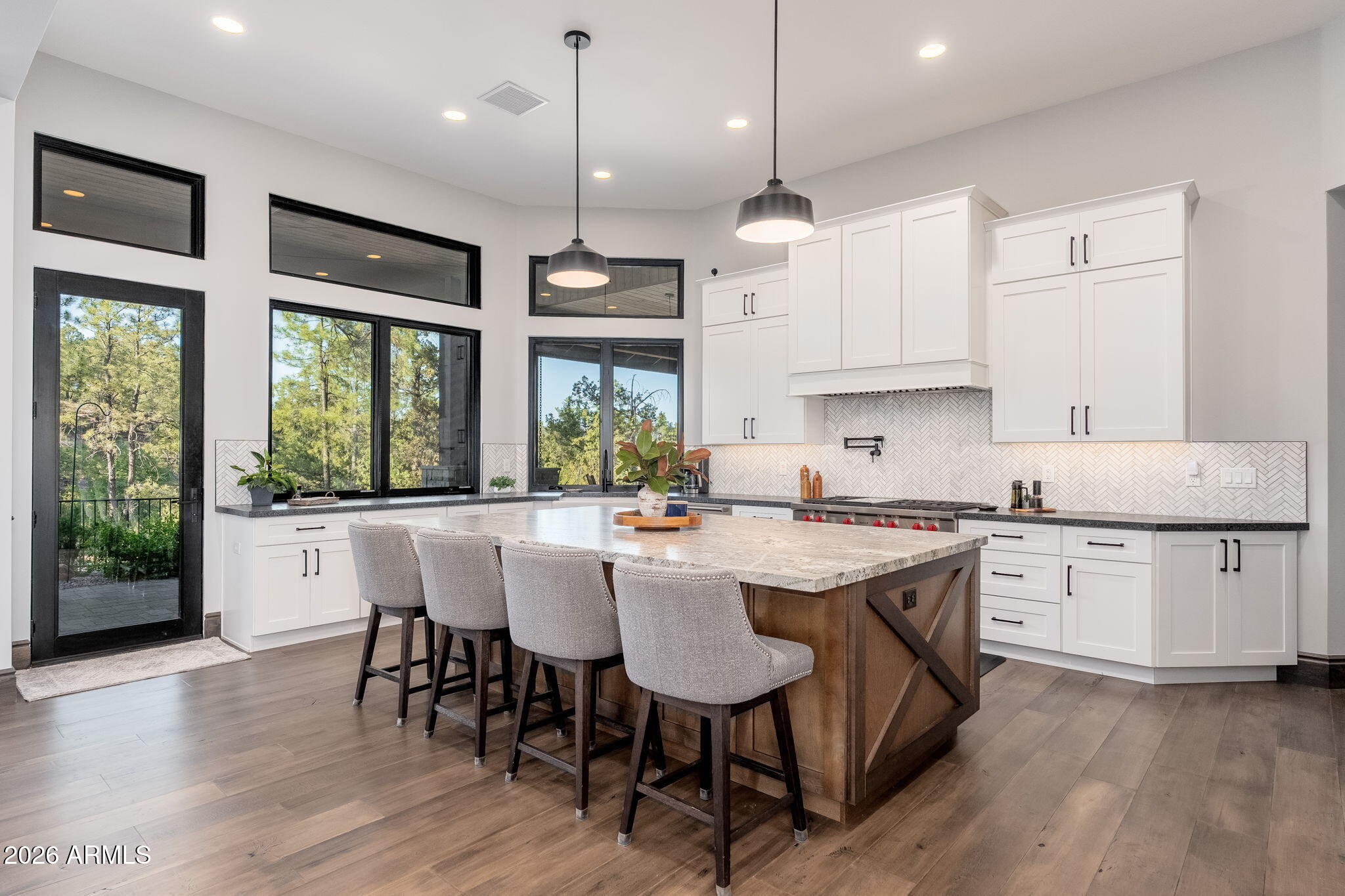 602 North Redbud Circle Payson, AZ 85541 - Photo 18 of 83 a kitchen with stainless steel appliances granite countertop a stove a refrigerator a sink a dining table and chairs with wooden floor