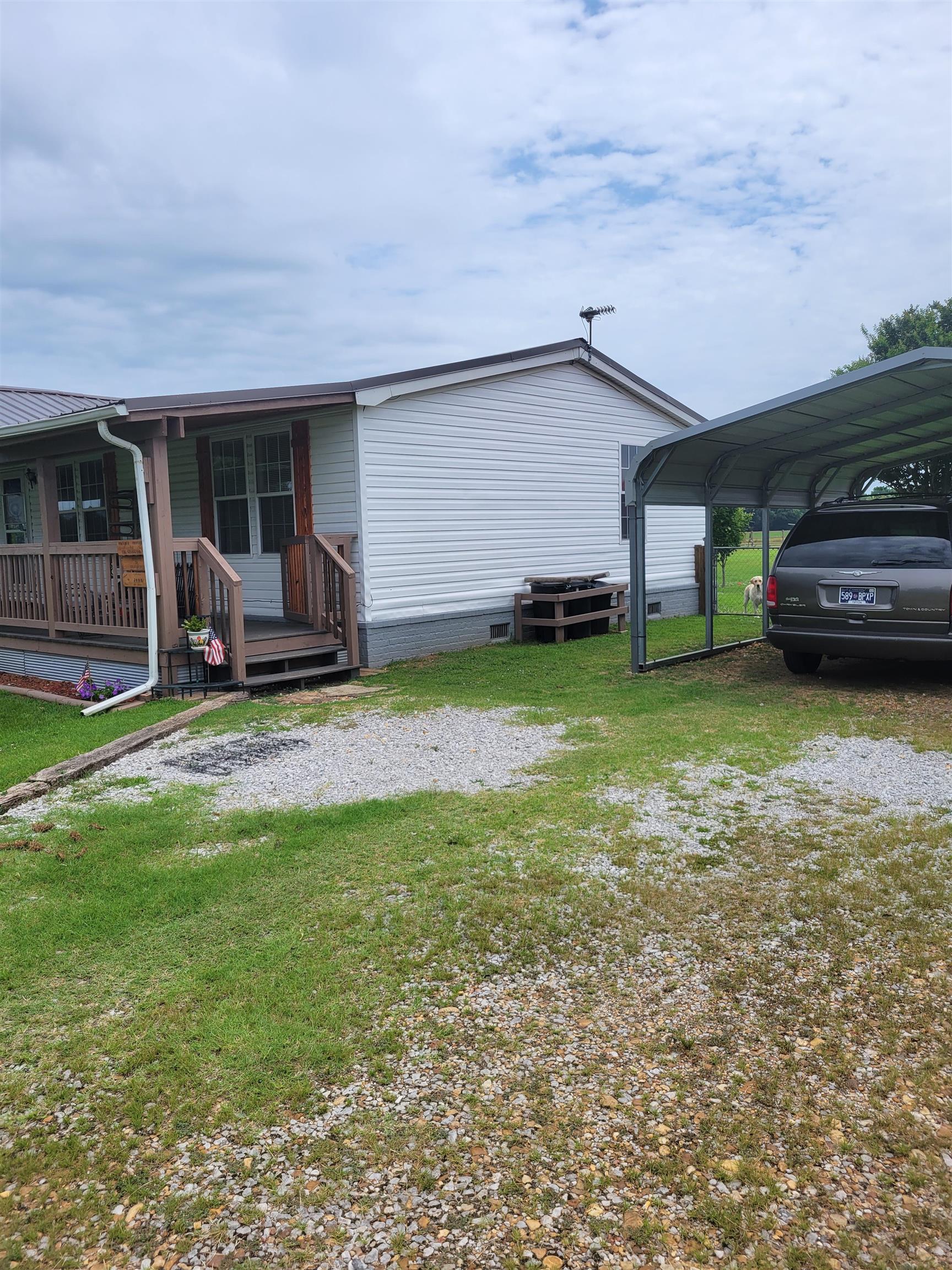 2496 Detroit Road Burlison, TN 38015 - Photo 3 of 25 View of home's exterior featuring a lawn, a detached carport, and crawl space