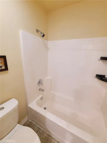 a bathroom with a bathtub and a toilet