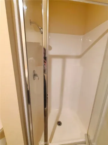 a bathroom with a shower and a sink