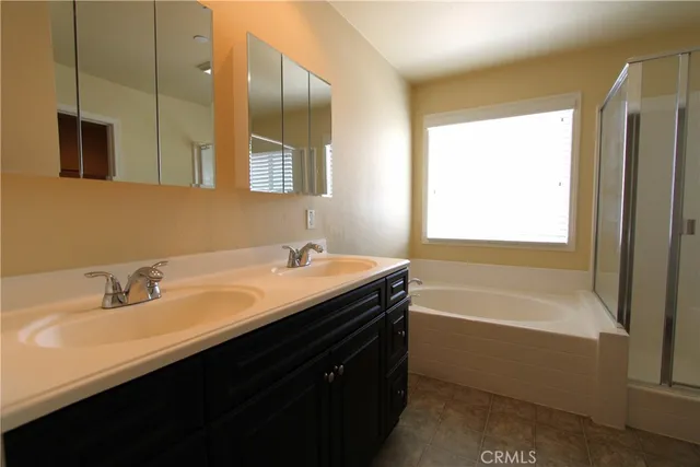 a bathroom with a tub sink and mirror