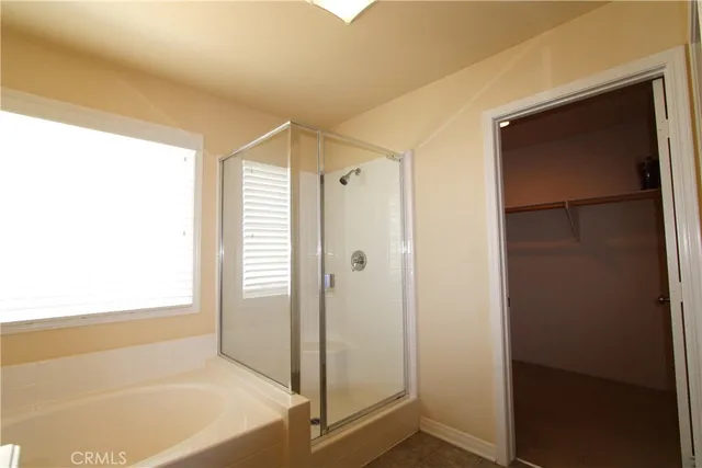 a bathroom with a bathtub and a shower