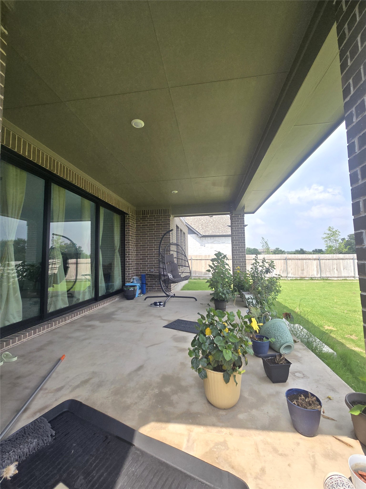124 Ribera Drive Liberty Hill, TX 78642 - Photo 35 of 40 A spacious covered patio offers a comfortable outdoor living area with a view of the private yard.