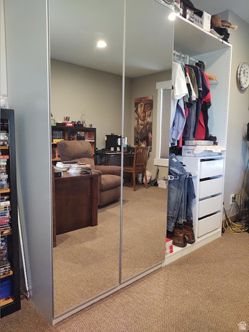 2170 Highway 357 Beaver, UT 84713 - Photo 45 of 56 Mirrored sliding wardrobe doors with an integrated open shelving system, featuring multiple hanging rods and white drawer units
