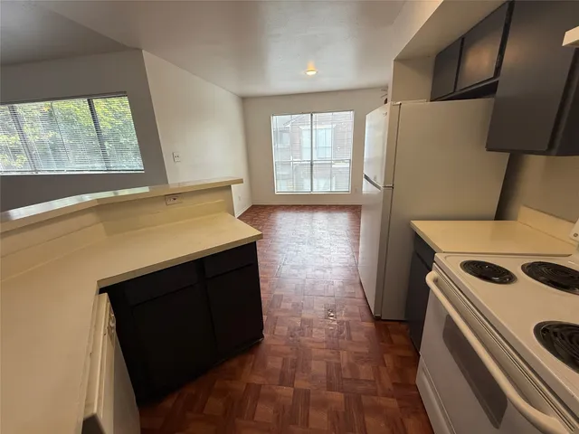 a white stove top oven sitting inside of a white refrigerator