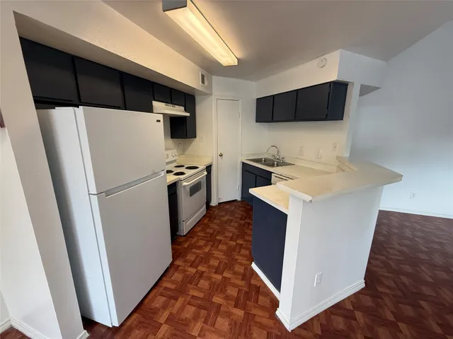 a white toilet and tub next to a shower