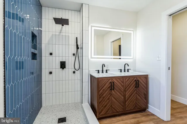 a bathroom with a sink a mirror and shower
