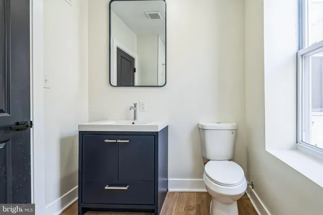 a bathroom with a toilet sink and mirror
