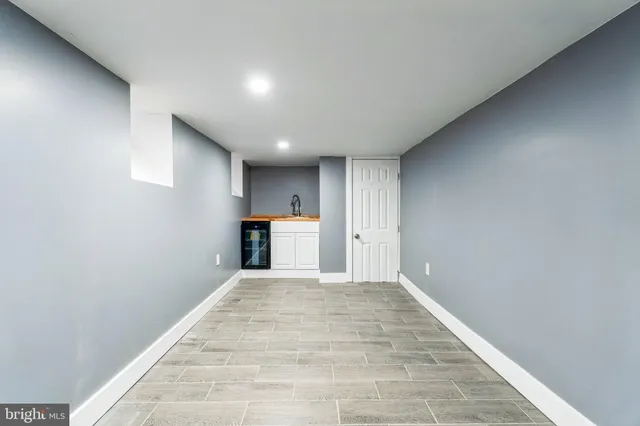 a view of a kitchen with a sink and a refrigerator