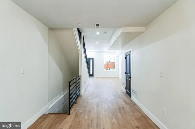 a view of hallway with wooden floor