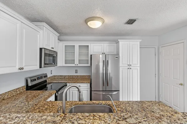 a bathroom with a sink mirror and toilet