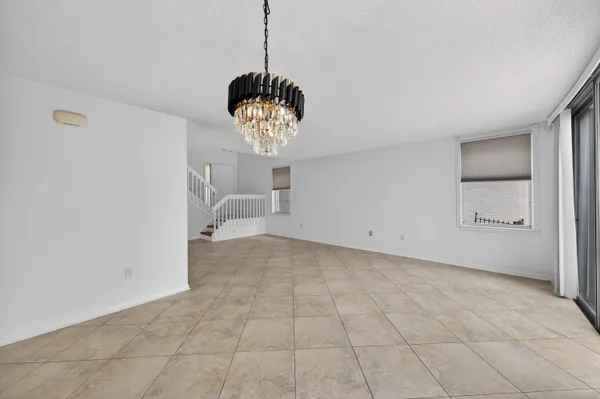 a spacious bathroom with a granite countertop sink a toilet and a mirror
