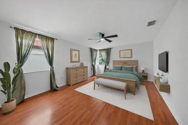 a bedroom with a bed and a flat screen tv