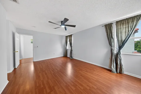 an empty room with ceiling fan