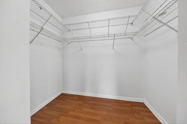 an empty room with closet and ceiling fan