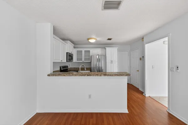 a kitchen with stainless steel appliances granite countertop a refrigerator sink and stove
