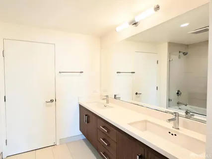a bathroom with a double vanity sink mirror and double